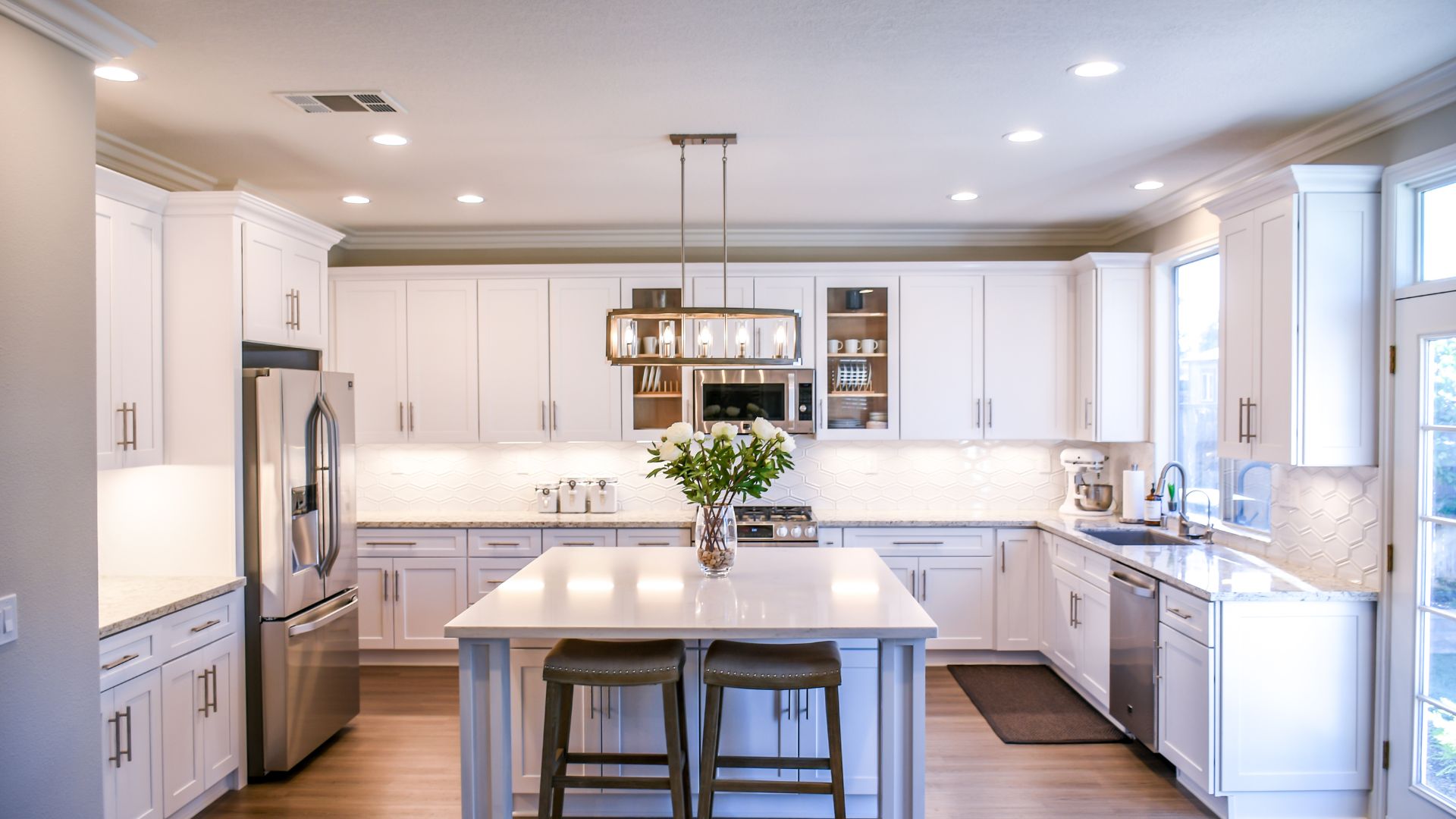 A kitchen with a center island with stools