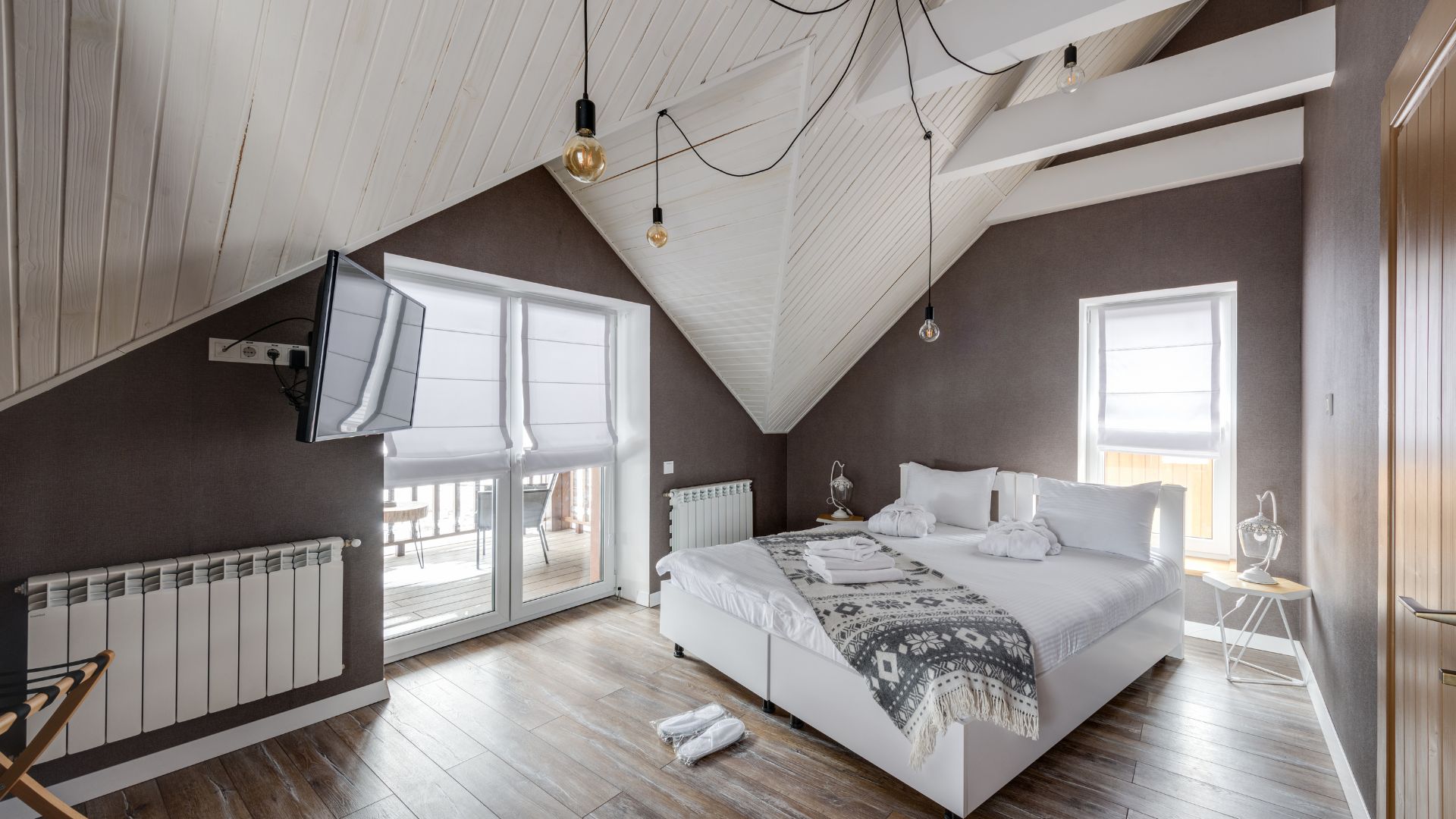 A bedroom with a large bed and a flat screen tv