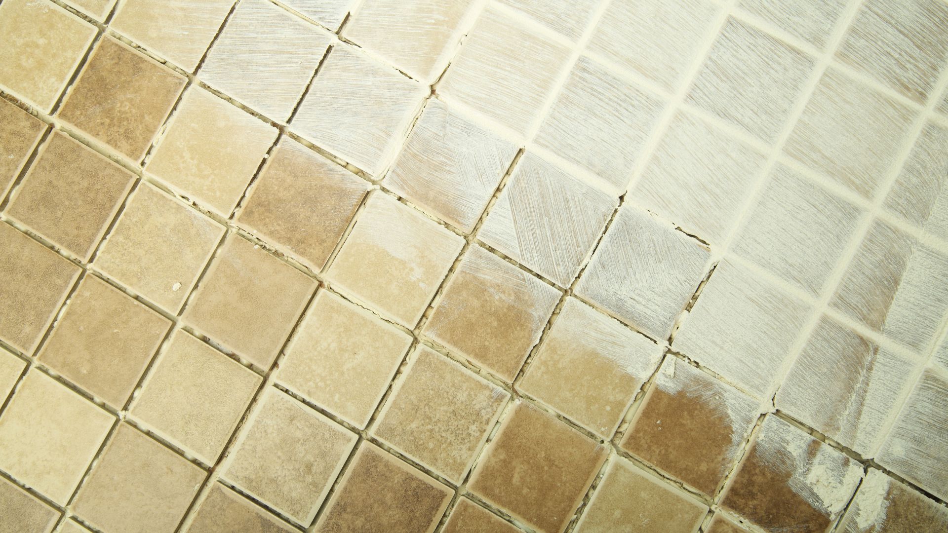 A close up of a bathroom floor with a tile pattern